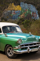 Old american car with colourful mural wall from Vinales, Cuba