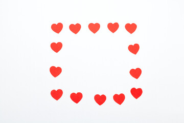 Red hearts made of paper on a white background. Top view. Valentine's Day. Symbol of love.