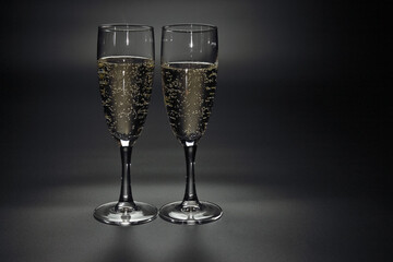 glasses with champagne on a dark background