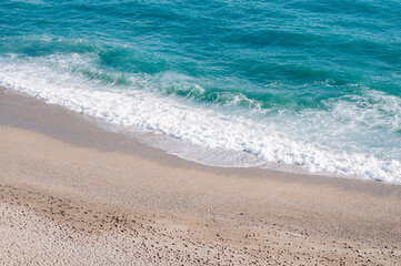 Beautiful beach, small grains of sand and blu waves