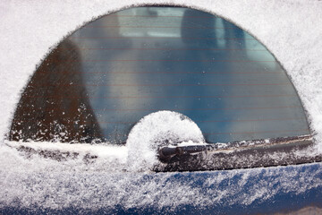car wiper removing thick snow layer frpm car rear window