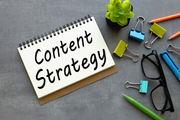 content strategy. open notepad with text on a gray background multi-colored stationery. creative