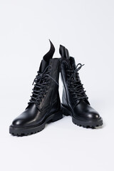 Black women's leather lace-up boots from the new collection on a white background from leather autumn-winter 2022. Boots close-up