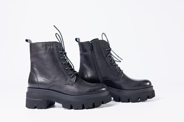 Women's black leather boots on a white background. Shoes and options for its layout. Autumn shoes. Boots. Autumn boots. Shoes close up