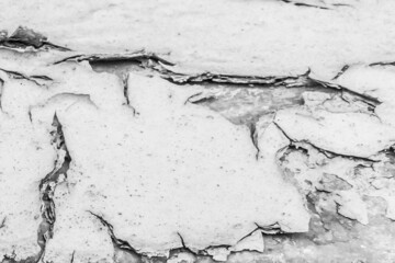 Cracked white paint on old weathered surface texture abstract background pattern