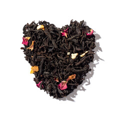 Heart shaped heap of dried black tea isolated on white background. Top view.