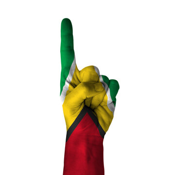Hand pointing thumb up direction, guyana painted with flag as symbol of up direction, first and number one symbol - isolated on white background