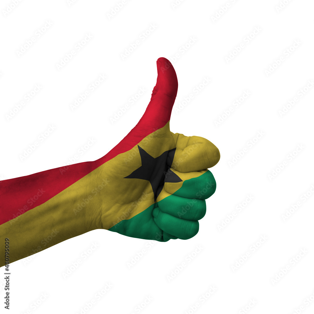 Wall mural Hand making thumbs up sign, ghana painted with flag as symbol of thumbs up, like, okay, positive  - isolated on white background