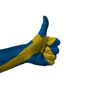Hand making thumbs up sign, sweden painted with flag as symbol of thumbs up, like, okay, positive  - isolated on white background