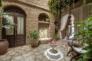 Interior patio to take in the cool in summer with decorative indoor plants and fountains