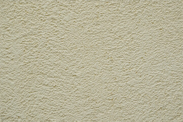 Full frame image of cement or concrete wall painted light yellow color. High resolution seamless texture of textured relief plaster for 3d models, background or collage, copy space