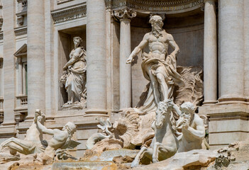 Fototapeta na wymiar Mythical Oceanus and titan statues on Fontana di Trevi Fountain in front of Palazzo Poli Palace in Trevi quarter of historic Old Town city center of Rome in Italy