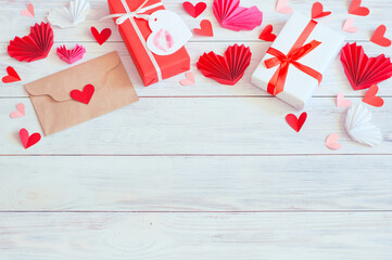 gift boxes and red hearts with a craft envelope on a wooden background. High quality photo
