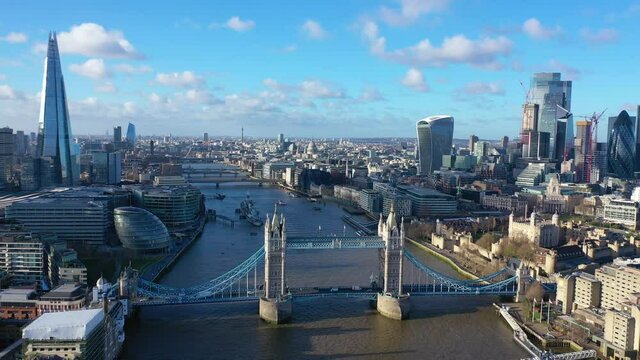 Aerial drone video of iconic Tower Bridge, Tower of London and skyline in financial area of City of London, United Kingdom