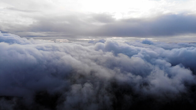 Amazing Aerial Shot: Drone Flying Over Fluffy Blue and White Clouds.