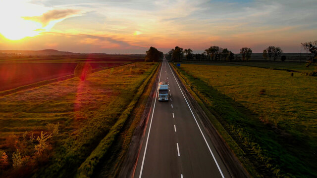 Amazing Aerial Drone View: White Lorry Delivering Goods by Road.