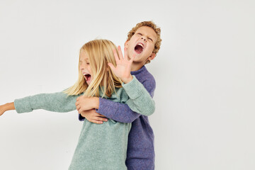 Portrait of cute children gesticulate with their hands together isolated background