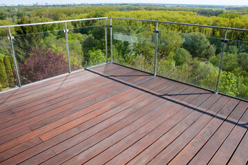 Contemporary architecture apartment balcony view with grooved cumaru wood decking and glass fence
