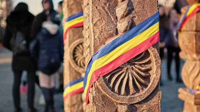 A stone post made in national style with Romanian flag in Iasi, Romania.