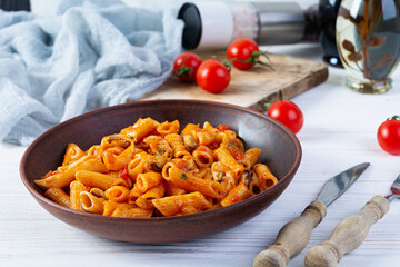 Pasta penne in marinara sauce with mussels, onion and parsley. Classic Italian pasta penne