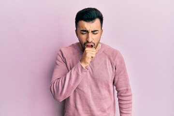Young hispanic man wearing casual clothes feeling unwell and coughing as symptom for cold or...
