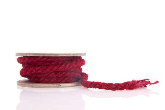 Red rope on wooden roll