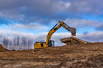 excavator and Articulated Dump Truck - obrazy, fototapety, plakaty