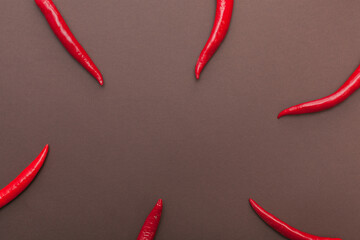 red chili peppers on brown background