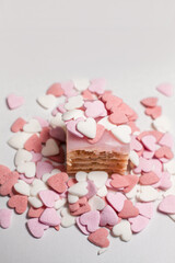 small cake sprinkled with decorative heart shaped sugar beads