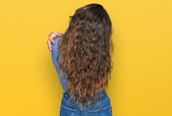 Young hispanic girl wearing casual clothes hugging oneself happy and positive from backwards. self...