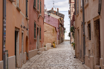 Empty, old, stone paved narrow streets of Rovinj, popular tourist destination with beautiful, colorful houses in the Istrian region of Croatia