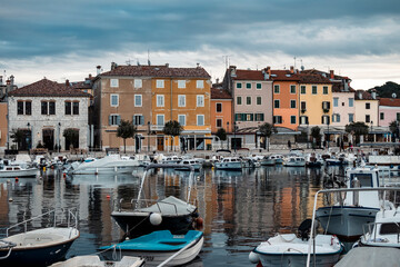 Beautiful, colorful houses, traditional to Istria peninsula of Croatia, in the famous tourist town of Rovinj, next to the town port full of boats