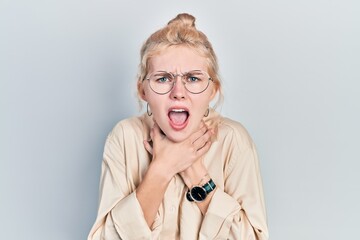 Beautiful caucasian woman with blond hair wearing casual look and glasses shouting and suffocate because painful strangle. health problem. asphyxiate and suicide concept.