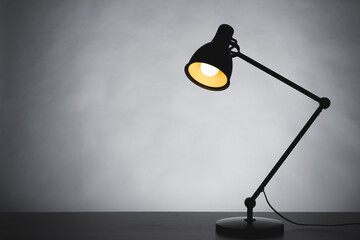 desk lamp silhouette, gray background with copy-space