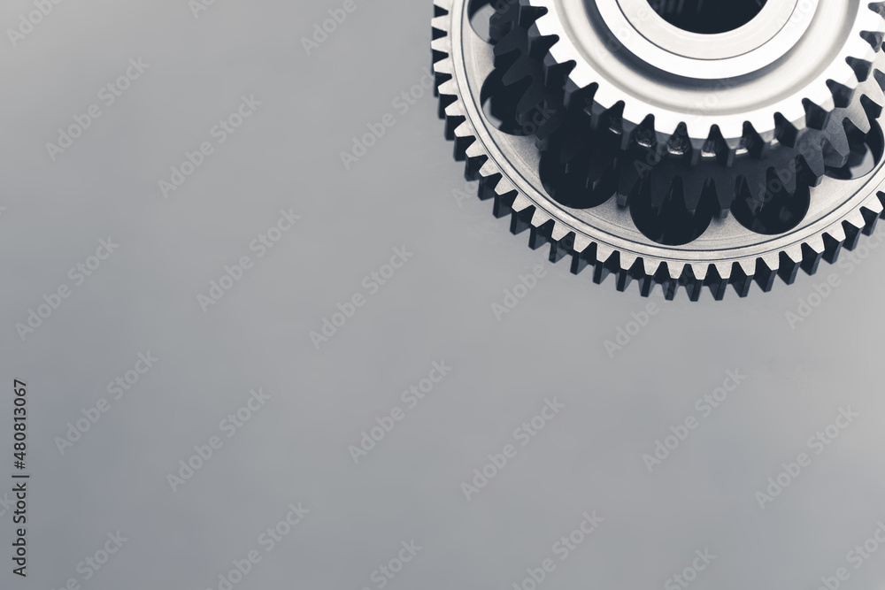 Poster gear wheel steel on gray background with copy-space