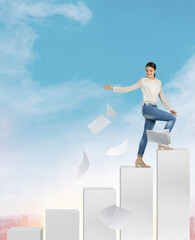 Young happy smiling brunette caucasian woman speaks on the phone and scatters paper stands at the top of the career ladder on the background of the blue sky, concept of freedom success rise promotion