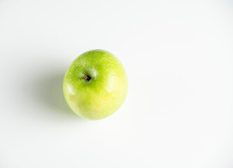 a whole green apple on a white background