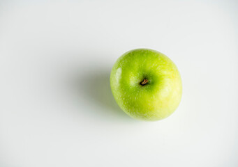 a whole green apple on a white background
