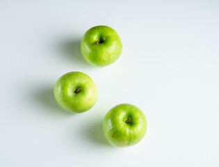a whole green apple on a white background