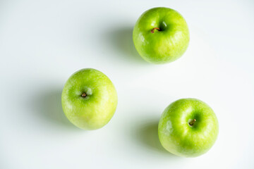 a whole green apple on a white background