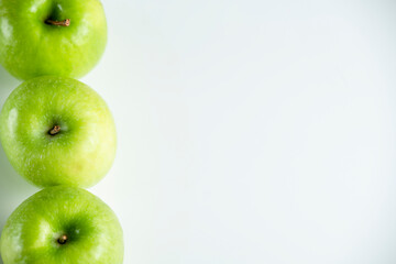 a whole green apple on a white background