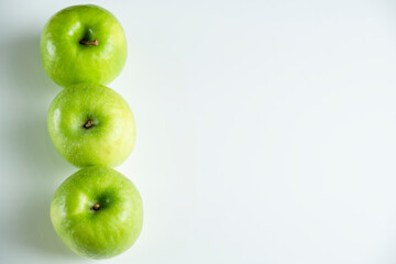 a whole green apple on a white background