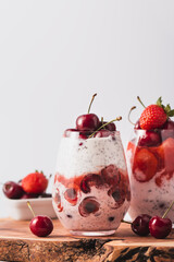 Yogurt Parfaits with cherry and strawberry on wooden table