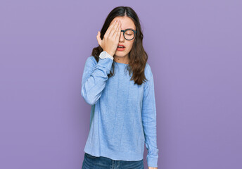 Young beautiful woman wearing casual clothes and glasses yawning tired covering half face, eye and mouth with hand. face hurts in pain.