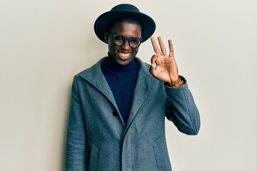 Young african american man wearing elegant style smiling positive doing ok sign with hand and fingers. successful expression.