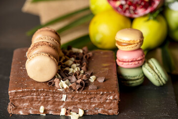 chocolate cake and a bouquet of fruits, from an apple, an orange, a lemon, a pomegranate, a grapefruit and a palm branch