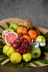 bouquet of fruits, from apple, orange, lemon, pomegranate, grapefruit and palm branch