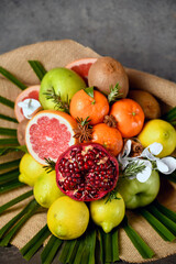 bouquet of fruits, from apple, orange, lemon, pomegranate, grapefruit and palm branch