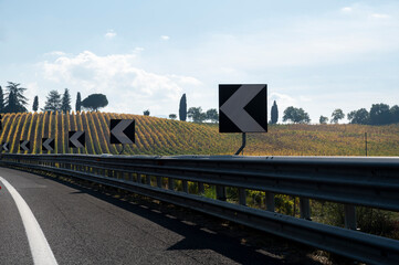 Driving on Italian highway with view on Chianti vineyards on hills in Tuscany, Italy