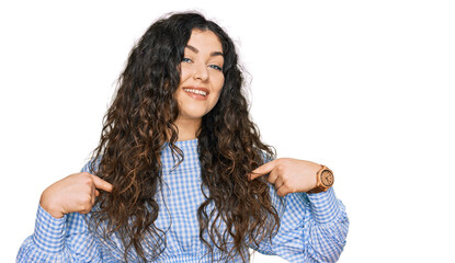 Young hispanic girl wearing casual clothes looking confident with smile on face, pointing oneself with fingers proud and happy.